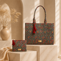 A matching laptop bag and small zip pouch with a geometric diamond pattern in red, orange, and dark green on a black base.