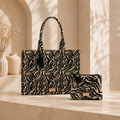 A black and beige zebra-print laptop bag  and a matching zip pouch.